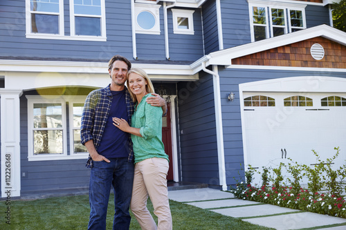 Portrait Of Couple Standing Outside House photo