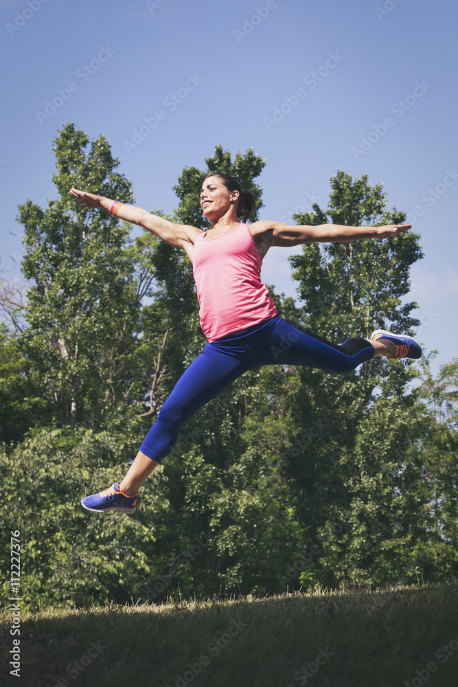 Woman doing jumping exercises in nature Woman doing jumping exercises in nature