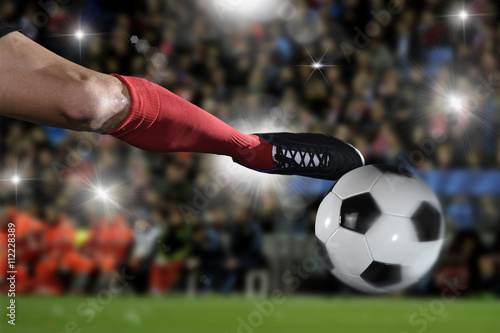 close up legs and soccer shoe of football player in action kicking ball playing in stadium © Wordley Calvo Stock