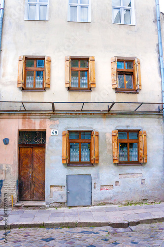 Fototapeta Naklejka Na Ścianę i Meble -  old city building with shuttered windows