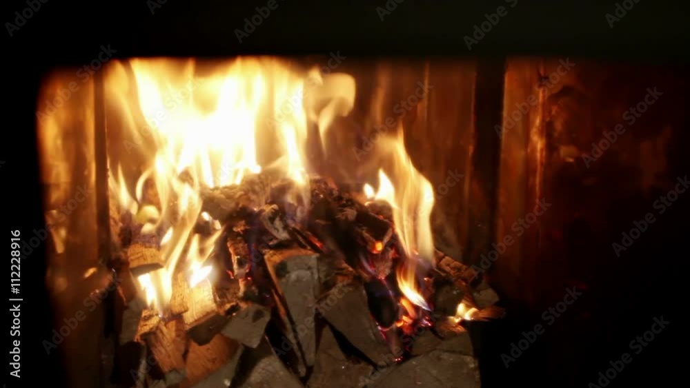 Russian bathhouse. Close-up shot of the flame in the furnace of the wood stove Russian bathhouse. Close-up shot of the flame in the furnace of the wood stove