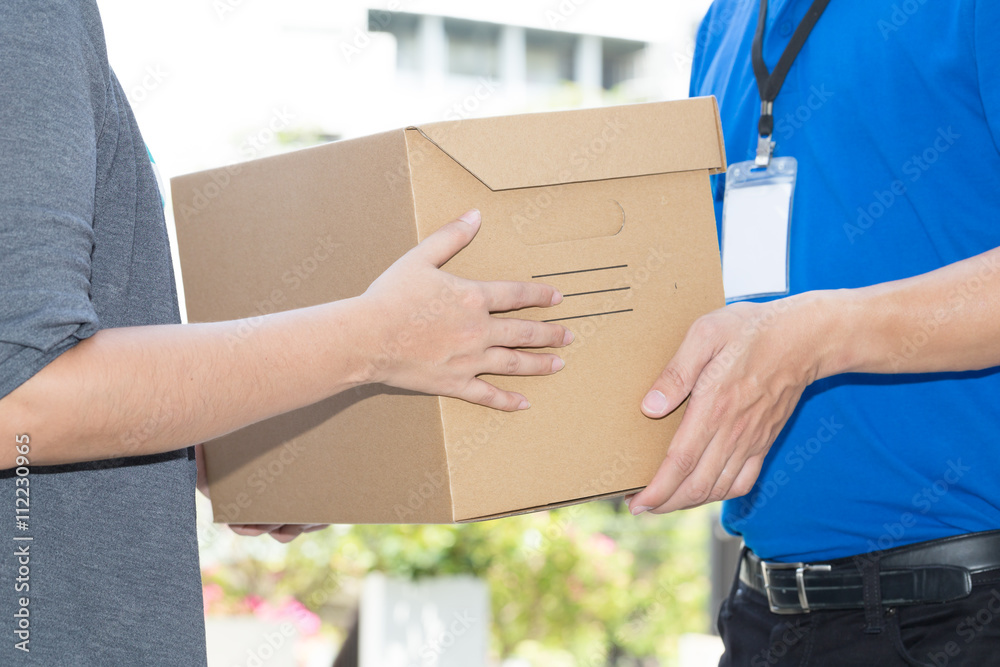 Woman hand accepting a delivery of boxes from deliveryman Woman hand accepting a delivery of boxes from deliveryman
