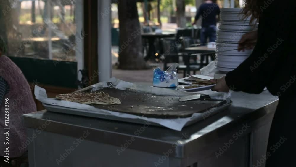 Turkish national food, The woman cuts the cake knife and puts it on a plate Turkish national food, The woman cuts the cake knife and puts it on a plate