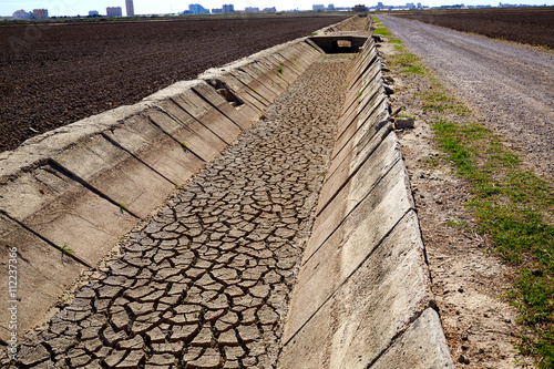 Dried irrigation ditch clay soil in Albufera fields