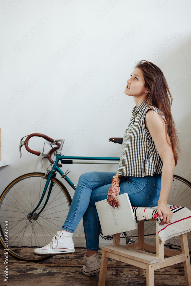 Young woman sipping coffee or tea and reading magazine Young woman sipping coffee or tea and reading magazine