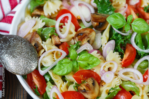 Warm salad of Farfalle with mushrooms and tomatoes 
