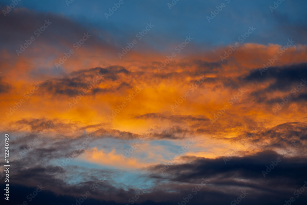 Sunset orange clouds in a blue sky