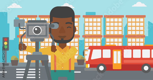 Cameraman with movie camera on a tripod.