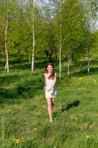 beautiful girl running outdoors in summer