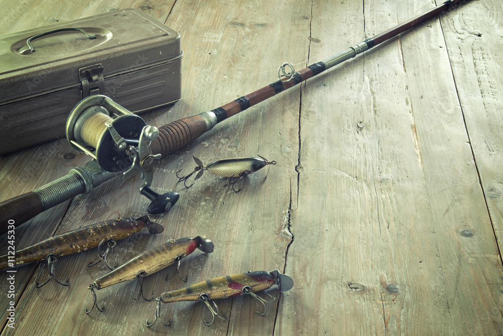 Antique fishing rod with lures net and bobbers on grunge wood surface Stock  Photo