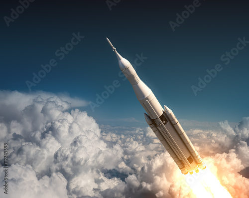 Fototapeta Naklejka Na Ścianę i Meble -  Space Launch System Flying In The Clouds
