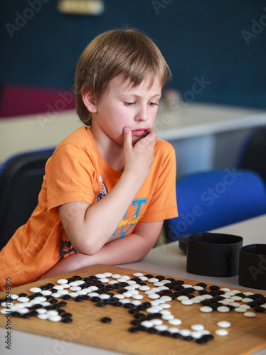 boy playing go (board game)
