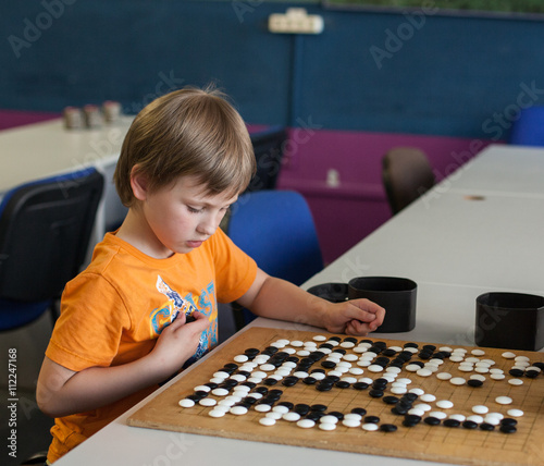 boy playing go (board game)

