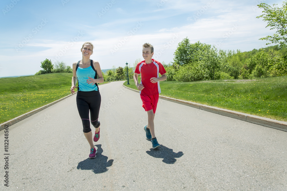 Fototapeta premium Family, mother and son are running or jogging for sport outdoors