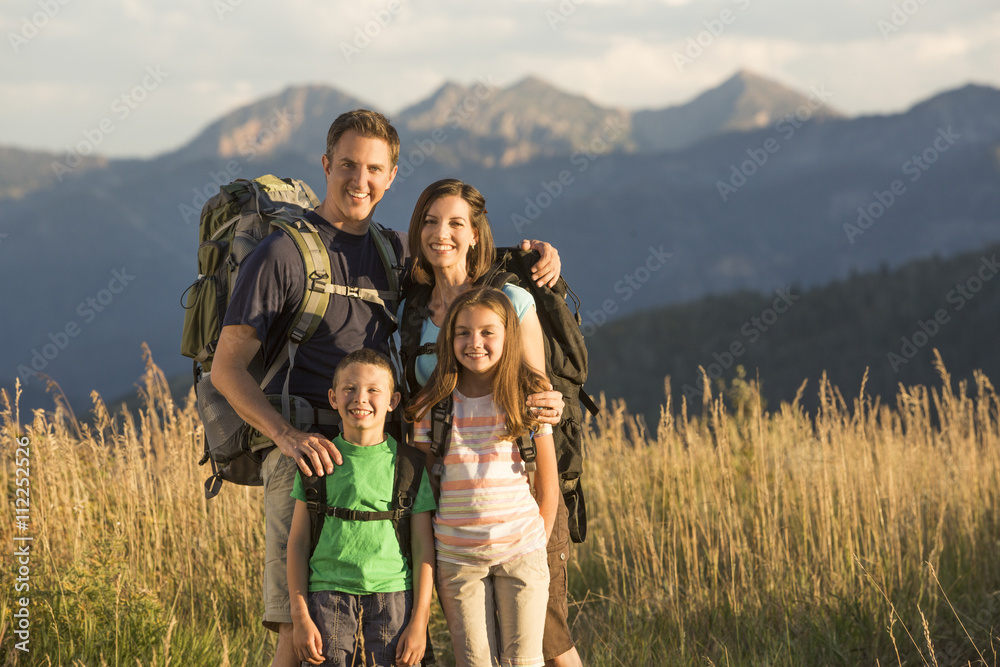 Caucasian family smiling in remote landscape Caucasian family smiling in remote landscape