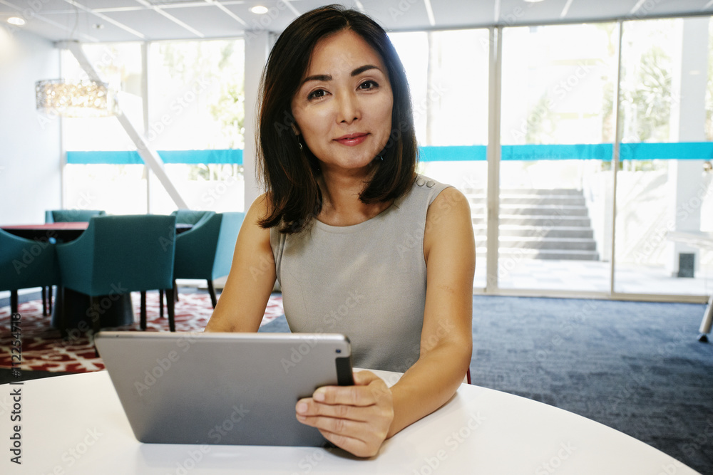 Portrait of businesswoman using digital tablet in office Portrait of businesswoman using digital tablet in office