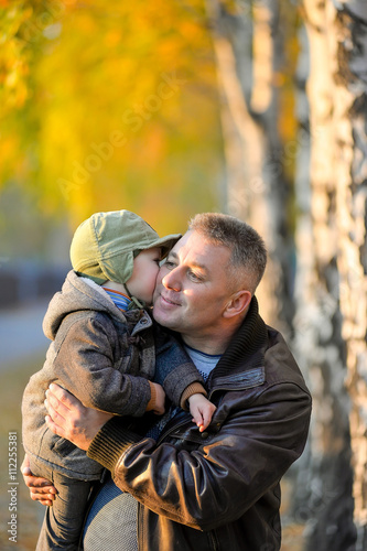 Father playing with his son in the park in autumn. © sergo321