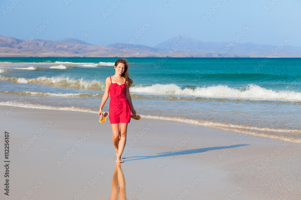 Attractive young woman walking on the beach Attractive young woman walking on the beach