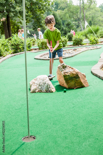 Child Playing Miniature Golf