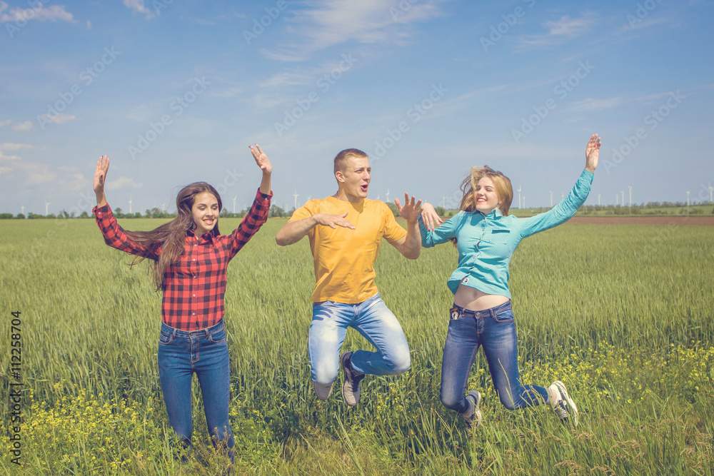 Young happy Friends running on green wheat field Young happy Friends running on green wheat field