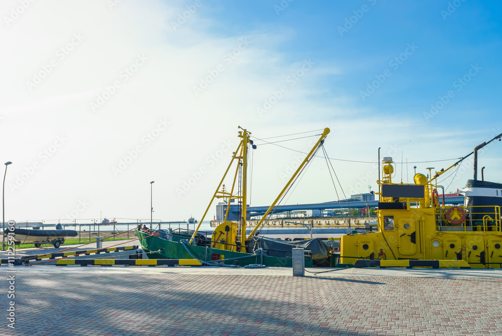 Dry cargo vessel and boat in port of Ventspils Dry cargo vessel and boat in port of Ventspils