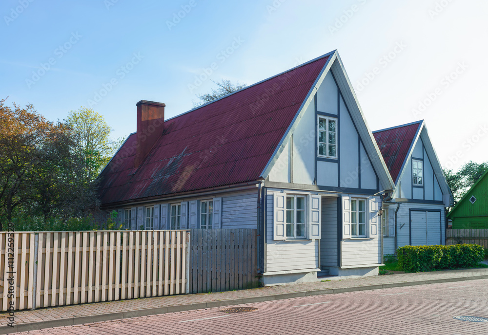 Old wooden house with wooden fence in Ventspils of Latvia Old wooden house with wooden fence in Ventspils of Latvia