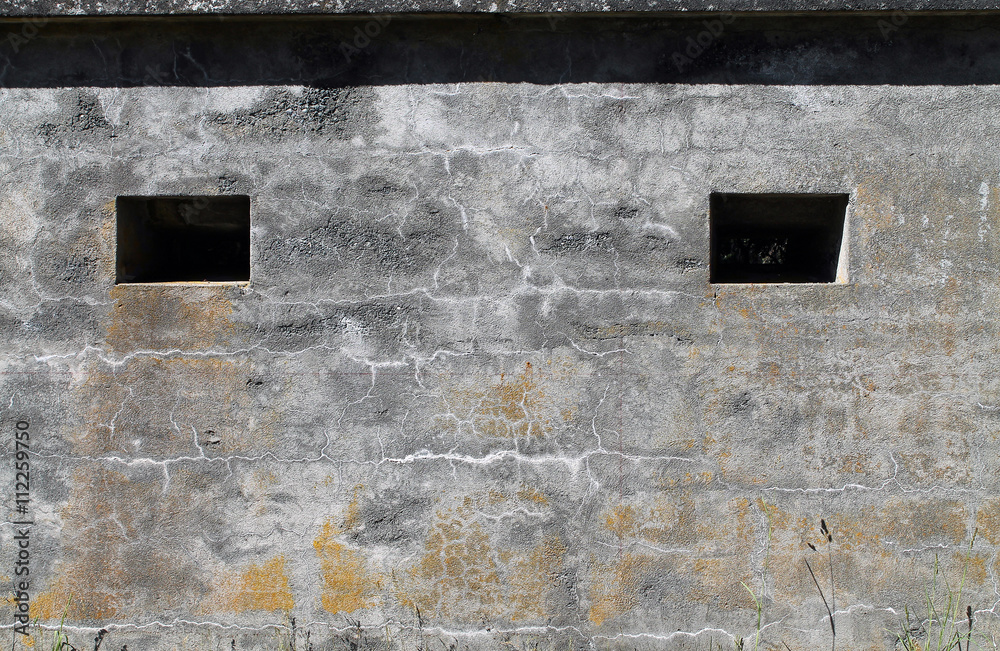 Two Windows in the Cement Wall of a Military Bunker