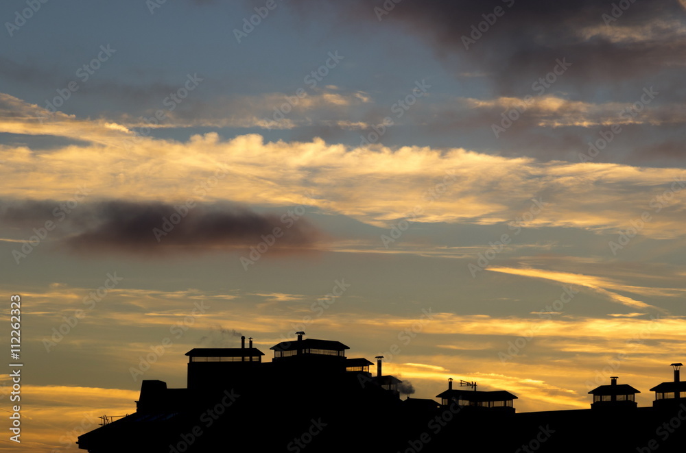 Beautiful sunset over roofs of houses