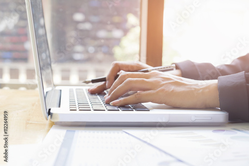 Business woman's hands typing on laptop keyboard. photo