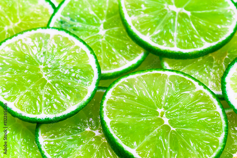 Green background with citrus-fruit of lime slices Green background with citrus-fruit of lime slices