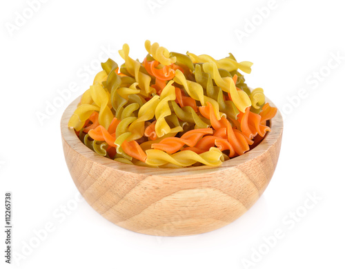 small vegeroni Rotini spirals pasta in wooden bowl on white back photo