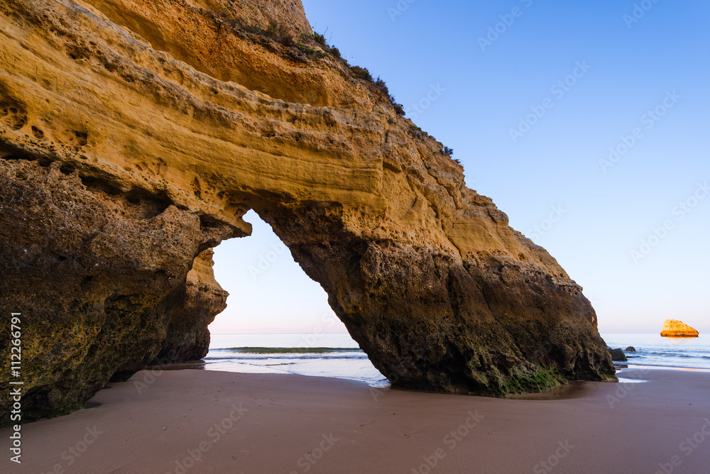 Beautiful natural arch on the beach of Praia da Rocha, Portimao Coast. Algarve region. Portugal