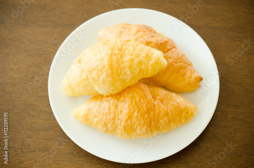 Croissant on white plate,breakfast,meal