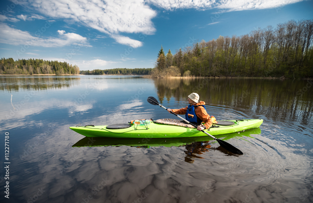 Kayaker on the lake, paddling, active lifestyle - obrazy, fototapety, plakaty 