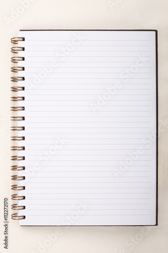 Blank Notebook with Line Paper on cement wall Background.