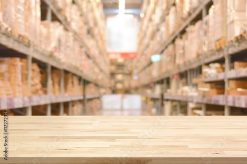 Empty wood table top on blurred warehouse background