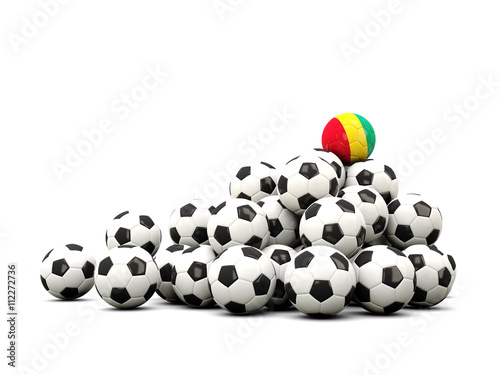 Pile of soccer balls with flag of guinea
