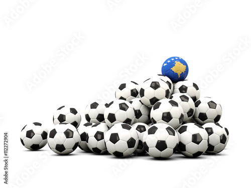 Pile of soccer balls with flag of kosovo