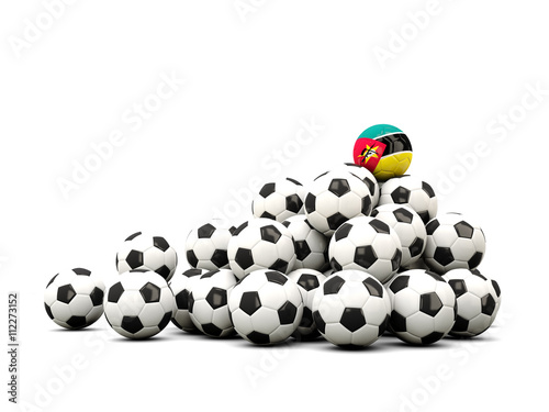 Pile of soccer balls with flag of mozambique