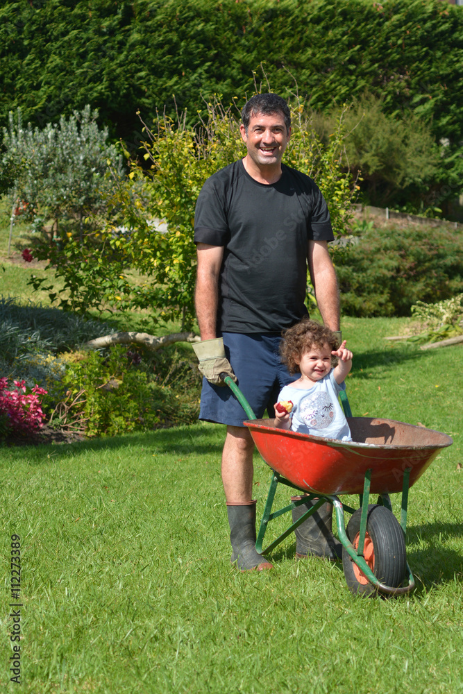 Man carry his daughter in a wheelbarrow Man carry his daughter in a wheelbarrow