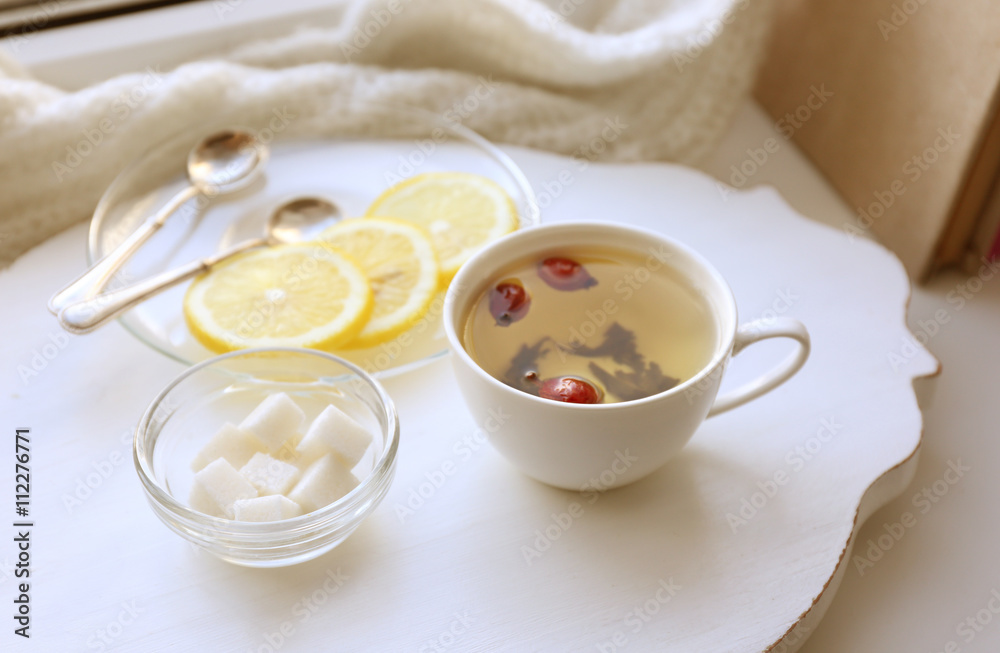 Tea set on a white wooden tray on the windowsill Tea set on a white wooden tray on the windowsill