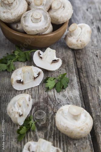 Raw mushrooms in a bowl on a table