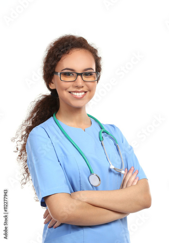 Beautiful African American female doctor on white background