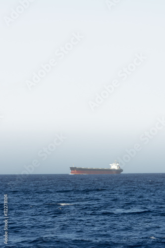 cargo ship sailing in still water © Dan Kosmayer