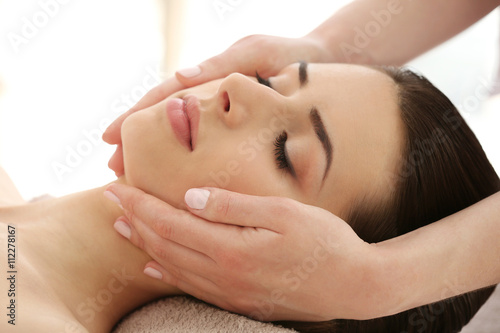 Young woman having massage ...