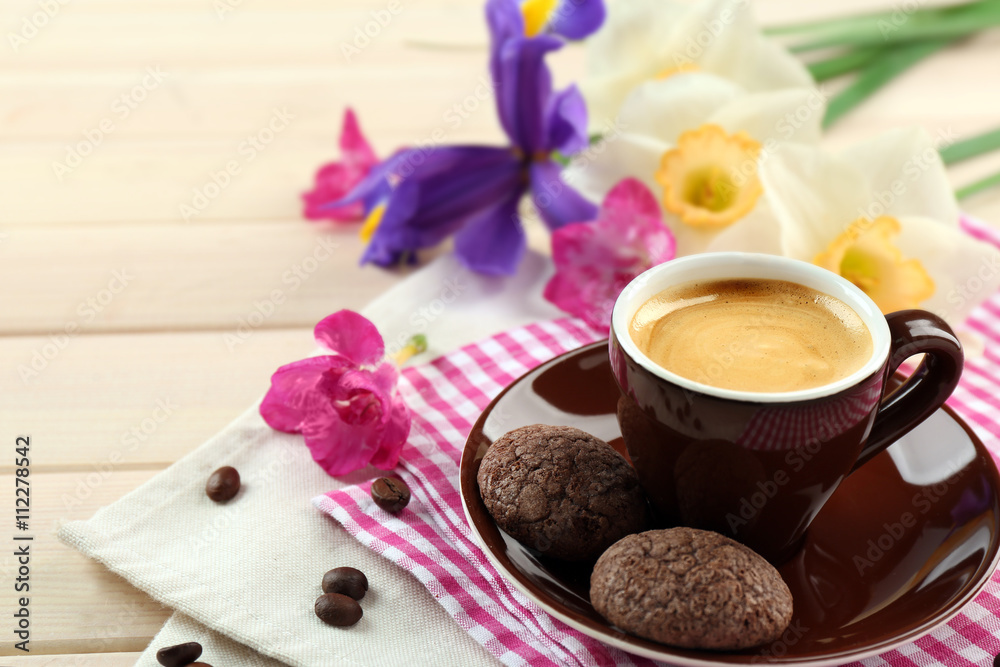Cup of coffee with cookies and flowers on wooden table Cup of coffee with cookies and flowers on wooden table