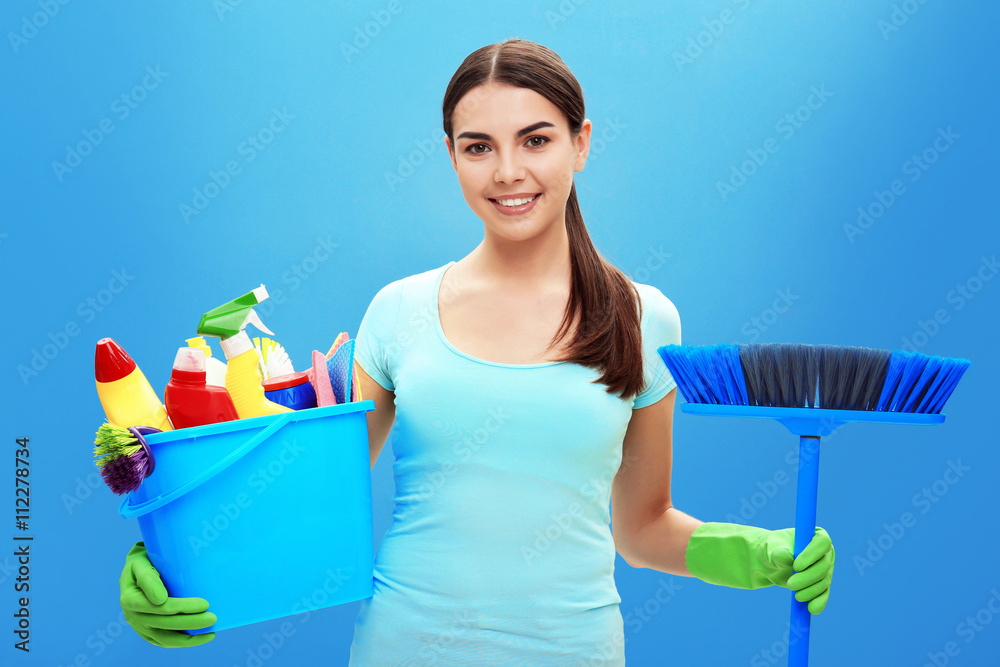 Female cleaner on blue background Female cleaner on blue background