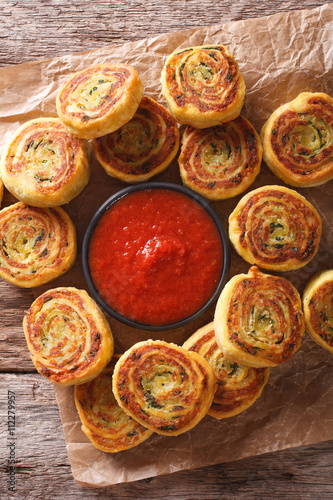 sliced potato rolls with tomato sauce close up. Vertical top view
 photo