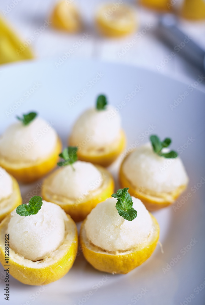 Lemon sorbet or ice cream inside fresh lemons Lemon sorbet or ice cream inside fresh lemons