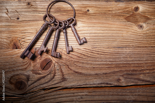 rusty medieval keys on wood table